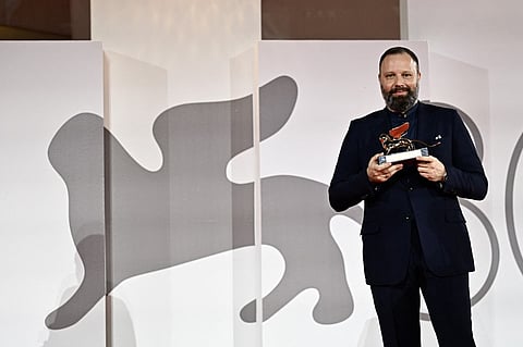 Director Yorgos Lanthimos poses with the Golden Lion for Best Film he reveived for 'Poor Things' during a photocall for winners at the 80th Venice Film Festival on 9 September 2023 at Venice Lido. (Photo by GABRIEL BOUYS / AFP)