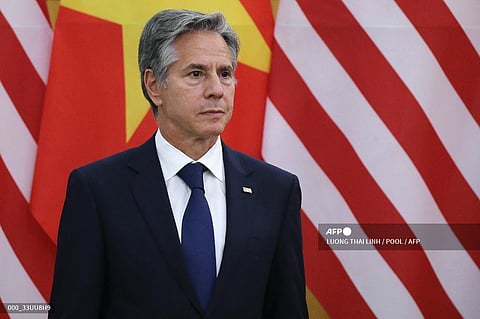 US Secretary of State Antony Blinken listens as US President Joe Biden and Vietnam's Communist Party General Secretary Nguyen Phu Trong speak to the media after a meeting at the Communist Party of Vietnam Headquarters in Hanoi on September 10, 2023. Biden travels to Vietnam to deepen cooperation between the two nations, in the face of China's growing ambitions in the region. (Photo by LUONG THAI LINH / POOL / AFP)