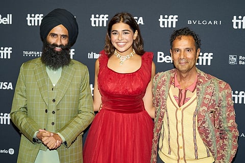 Actors Kanwar Grewal (L) and Pavia Sidhu (C) and director Tarsem Singh Dhandwar pose for photographers at the premiere of Dear Jassi at the Toronto International Film Festival in Toronto, Ontario, on 10 September 2023. (Photo by Geoff Robins / AFP)