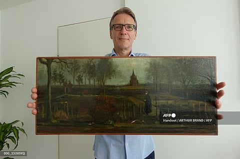 An handout picture released by Dutch art detective Arthur Brand shows a portrait of him posing with the painting title "Parsonage Garden at Nuenen in Spring", painted by Vincent van Gogh in 1884, at his home in Amsterdam on September 11, 2023. Brand has recovered a precious Vincent van Gogh painting that was stolen from a museum in a daring midnight heist during the coronavirus lockdown three-and-a-half years ago. Brand, dubbed the "Indiana Jones of the Art World" for tracing a series of high-profile lost artworks, told AFP that confirming the painting was the stolen Van Gogh was "one of the greatest moments of my life." (Photo by Handout / ARTHUR BRAND / AFP)