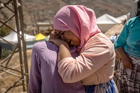 FADEL SENNA/AGENCE FRANCE-PRESSE
A woman grieves as rescuers recover a family member’s body from the rubble in the earthquake-ravaged village of Imi N’Tala near Amizmiz in Morocco on 13 September. Rescue teams stepped up a massive effort in devastated Moroccan mountain villages as chances fade for finding survivors from last week’s earthquake that killed 2,900 people and thousands homeless.