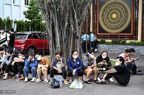 Relatives wait outside a funeral house during the identification of victims of the major fire at an apartment block in Hanoi on September 13, 2023. (Photo by AFP)