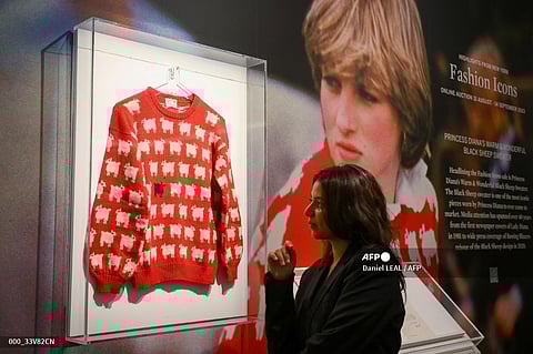 An iconic red sweater worn by Princess Diana shortly after her engagement to then-Prince Charles, featuring rows of fluffy little sheep, sold at auction for more than $1.1 million following a frenetic bout of final bidding, Sotheby's announced on September 14, 2023. Photo by Daniel LEAL / AFP