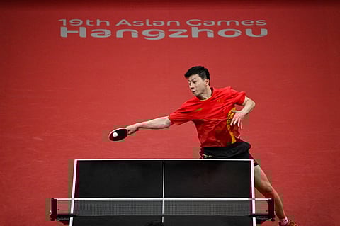 China's Ma Long hits a return against Taiwan's Liao Cheng-Ting in their men's Team Semifinal table tennis match during the Hangzhou 2022 Asian Games in Hangzhou, in China's eastern Zhejiang province on 25 September 2023. (Photo by Hector RETAMAL / AFP)