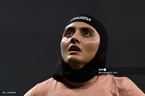 Afghanistan's Kimia Yousofi reacts after the women's 100m heats athletics event during the 2022 Asian Games in Hangzhou in China's eastern Zhejiang province on September 29, 2023. (Photo by WILLIAM WEST / AFP)