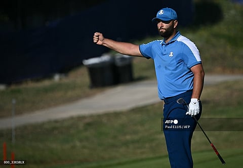 Europe's Spanish golfer, Jon Rahm celebrates chipping in on the 10th hole during his foursomes match on the first day of play in the 44th Ryder Cup at the Marco Simone Golf and Country Club in Rome on September 29, 2023. (Photo by Paul ELLIS / AFP)