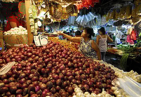 FILE PHOTO: Vendors wait for customers in a public market in suburban Manila as the price of goods has increased due to food shortages around the world. (Photo by LUIS LIWANAG / AFP)