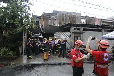 Personnel of the Bureau of Fire and Quezon City Disaster Risk Reduction and Management Office recovered the bodies of at least 15 persons who died in a fire that broke out in a residential area on Gloria Avenue, Barangay Tandang Sora in Quezon City Thursday morning on 31 August 2023. (Photograph by Analy Labor for The Daily Tribune)