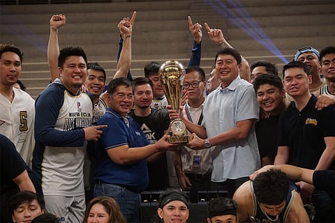 Nueva Ecija's Bong Cuevas (seen in file photo receiving the championship trophy from MPBL commissioner Kenneth Duremdes) calls on fellow team owners t safeguard the league from fly-by-night operators.