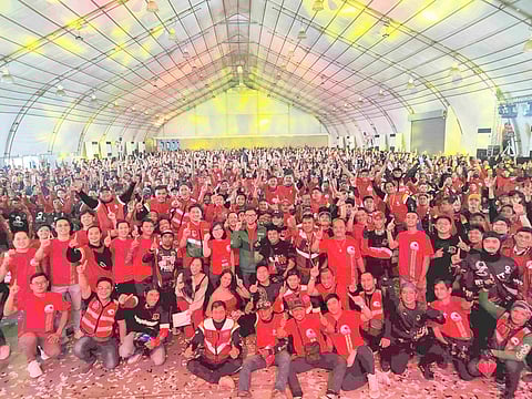Move It general manager Wayne Jacinto, Grab Philippines country head Grace Vera Cruz and head of mobility RJ Cabaluna (center) with thousands of Move It rider-partners at the recent ‘Tropang Malupet‘ program. | PHOTOGRAPHS COURTESY OF MOVE IT