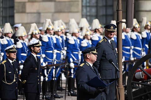 Sweden's King Carl XVI Gustaf (right) and the Prince Carl Philip of Sweden (second, left) oversee the Changing of the Royal Guard in the Outer Courtyard for the 50th anniversary of King Carl XVI Gustaf's accession to the throne at the Royal Palace in Stockholm, Sweden, on 15 September 2023. (Photo by Jonathan NACKSTRAND / AFP)