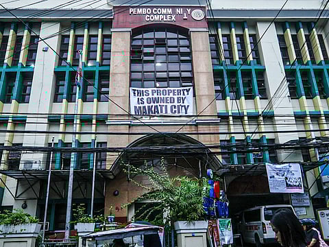 Makati City asserts ownership of PEMBO Community Complex in Taguig City through a prominently displayed tarpaulin stating: "This property is owned by Makati City." | PHOTOGRAPH BY DIANNE BACELONIA FOR THE DAILY TRIBUNE