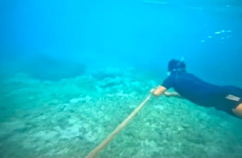 A Philippine Coast Guard troop removes the floating barriers placed by the China Coast Guard at the Bajo de Masinloc in Zambales. The PCG said the move is in compliance with the orders of President Ferdinand R. Marcos Jr. and National Task Force for the West Philippine Sea chair Secretary Eduardo Año. (Photo courtesy of PCG)