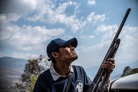FILE PHOTO: A Guerrero Community Police member patrols the hills in Heliodoro Castillo, Guerrero state, Mexico. (Photo by Pedro PARDO / AFP)