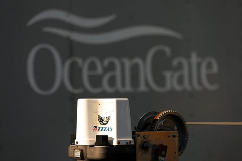 A decal on a piece of equipment which reads "Titan" is pictured near a trailer with the OceanGate logo at OceanGate Expedition's headqurters in the Port of Everett Boat Yard in Everett, Washington, on 22 June 2023. All five people aboard a submersible missing near the wreck of the Titanic died -- likely in an instant -- after their vessel suffered what the US Coast Guard said June 22, 2023 was a "catastrophic implosion" in the ocean depths. (Photo by Jason Redmond / AFP)