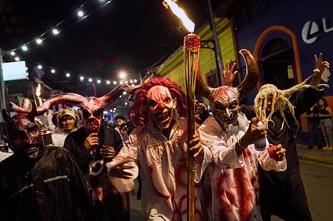 People with masks pose for a picture during the annual Los Aguizotes festival, in the indigenous neighbourhood of Monimbo in Masaya, Nicarag27, 2023. Thousands of people dressed as terrifying characters from legends took to the streets of Masaya, south of Managua, on Friday night for the festival of Los Agüizotes, famous for the masks made by artisans from the indigenous neighbourhood of Monimbo. (Photo by Oswaldo RIVAS / AFP)