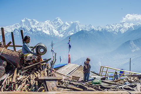 FILE: A woman from Singla village extracts her belongings from the rubble. 1 October 2023.