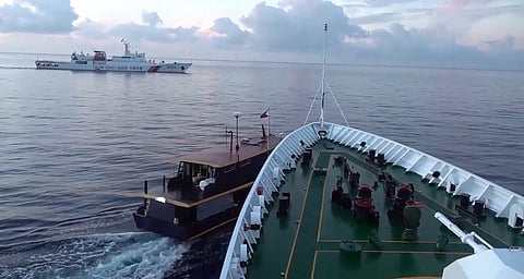 (FILES) This video frame grab from footage taken and released on 22 October 2023 by the Chinese Coast Guard, through the Chinese Embassy in Manila, shows a collision between a Chinese Coast Guard ship and a Philippine resupply boat during a resupply mission in Second Thomas Shoal. Beijing and Manila traded blame on 22 October for two collisions between Chinese vessels and Philippine boats on a resupply mission to Filipino troops on a remote outpost in the disputed South China Sea.