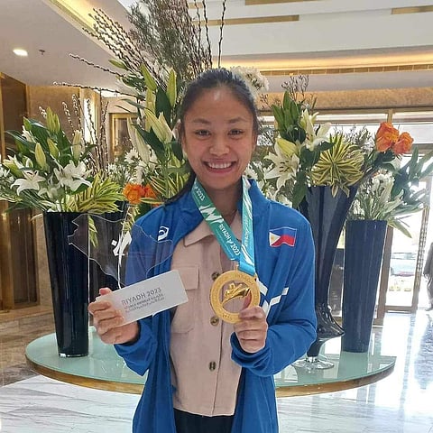 Kaila Napolis beams with pride and joy while showing her gold medal from the World Combat Games. | Photograph courtesy of Rhett Bettin