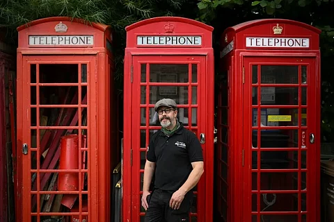 Redundant red and other phone boxes are increasingly being adopted by local communities and converted into facilities such as mini libraries, visitor information stands and defibrillators. (Photo: Daniel Leal / AFP)