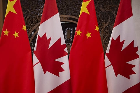 This picture taken on December 5, 2017, shows Canadian and Chinese flags taken prior to a meeting with Canada's Prime Minister Justin Trudeau and China's President Xi Jinping at the Diaoyutai State Guesthouse in Beijing. (Photo by Fred DUFOUR / POOL / AFP)