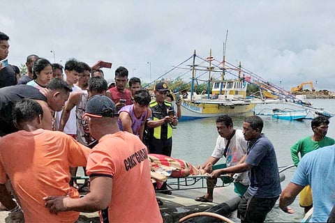 PCG/AGENCE FRANCE-PRESSE
Tragic collision at WPS Coast Guard personnel retrieve remains of one of three Filipino fishermen killed after their boat was fatally rammed on Monday by a foreign oil tanker off Bajo de Masinloc, Zambales.