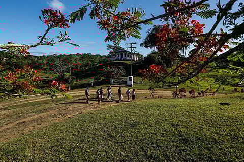 FILE PHOTO: Visitors walk around the Capela Velha cocoa farm, in Urucuca, Bahia state, Brazil, on 13 December 2019. (Photo by RAFAEL MARTINS / AFP)