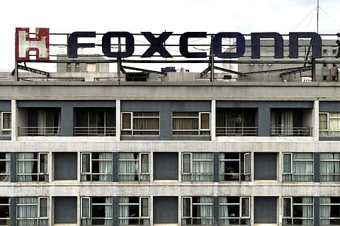 FILE PHOTO: This aerial photo shows a Foxconn logo on a building in Tucheng district, New Taipei City. (Photo by Sam Yeh / AFP)