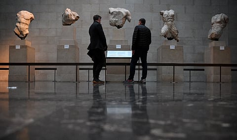 FILE: Visitors view the Parthenon Marbles, also known as the Elgin Marbles, at the British Museum in London on 9 January 2023. The ancient sculptures were taken from the Parthenon temple at the Acropolis in Athens in the early 19th century by British diplomat Thomas Bruce, the earl of Elgin. (Photo by Daniel LEAL / AFP)