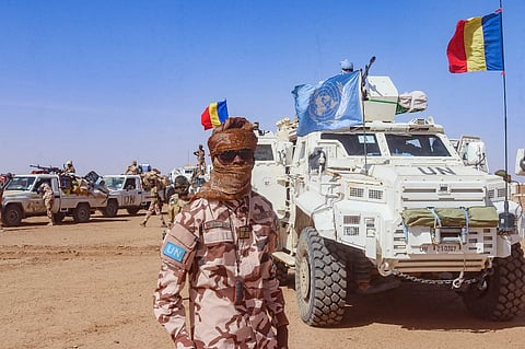 FILE PHOTO: This handout photo taken by MINUSMA on 25 October 2023 shows a Chadian soldier with the United Nations Multidimensional Integrated Stabilization Mission in Mali (MINUSMA) standing in front of a convoy outside the city of Gao, after withdrawing from their bases in Tessalit and Aguelok in the North of Mali. (Photo by MINUSMA / AFP)