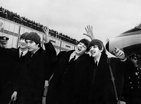 English band the Beatles with, from left to right, John Lennon, Ringo Starr, Paul McCartney and George Harrison, arrive at John F. Kennedy Airport in New York, United States on February 7, 1964. Photo by AFP