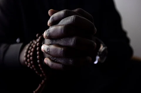 FILE PHOTO: A close up photo shows the hands of African faith healer Sheikh Issa before a consultation in his office in Paris. Photo by JOEL SAGET / AFP)