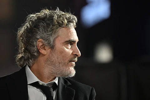 US actor Joaquin Phoenix reacts upon arrival on the red carpet for the UK Premiere of the movie "Napoleon" at the Odeon Luxe Leicester Square, central London, on 16 November 2023. (Photo by JUSTIN TALLIS / AFP)