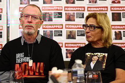 Orit Meir (R), mother of Almog Meir, cries next to Thomas Hand, father of Emily Hand, during a press conference by families of hostages held by Hamas in Gaza, at the embassy of Israel in London on 20 November 2023. (Photo by HENRY NICHOLLS / AFP)