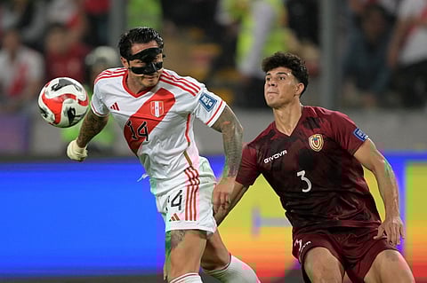 Peru's forward Gianluca Lapadula (L) fights for the ball with Venezuela's defender Yordan Osorio during the 2026 FIFA World Cup South American qualification football match between Peru and Venezuela at the National Stadium in Lima on 21 November 2023. (Photo by ERNESTO BENAVIDES / AFP)