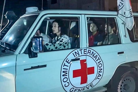 This image grab taken from an AFPTV video footage shows an International Red Cross vehicle reportedly carrying hostages released by Hamas crosses the Rafah border point in the Gaza Strip towards Egypt from where they would be flown to Israel to be reunited with their families, on 24 November 2023. Photo by Mahmud Hams / AFPTV / AFP