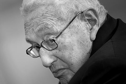 FILE PHOTO: Former US Secretary of State Henry Kissinger listens while he is introduced at a ceremony honoring his diplomatic career on 9 May 2016 at the Pentagon in Washington, DC. (Photo by Brendan Smialowski / AFP)