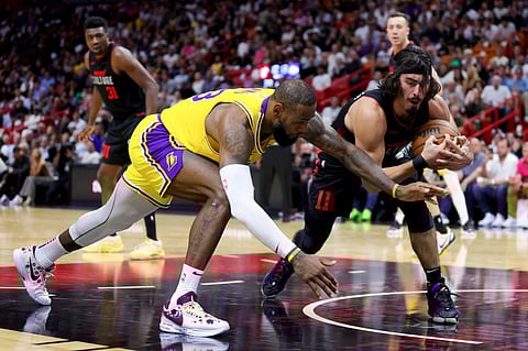 LeBron James, #23 of the Los Angeles Lakers, and Jaime Jaquez Jr., #11 of the Miami Heat, compete for the ball during the second quarter of the game at Kaseya Center on 6 November 2023 in Miami, Florida. (Photo by Megan Briggs / GETTY IMAGES NORTH AMERICA / Getty Images via AFP)