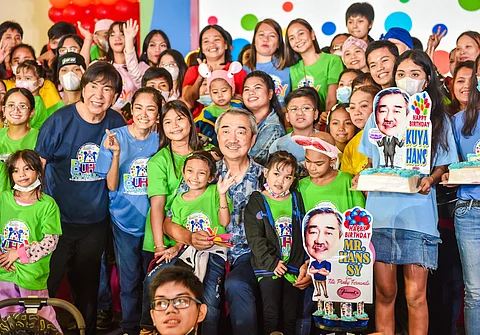 CHILD Haus founder 'Mader' Ricky Reyes and SM Prime Holdings Inc. Chairman of the Executive Committee Hans Sy (center) celebrate the institution's 21st anniversary with the CHILD Haus beneficiaries.