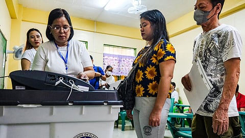 (FILE PHOTO) Voters are instructed to feed their ballot to the vote counting machine at the Pasong Tamo Elementary School, one of the few automated polling centers during the BSKE 2023 on Monday, 30 October 2023.