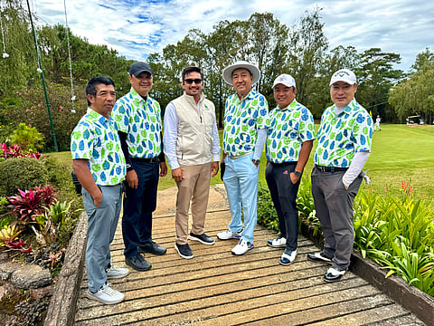 photograph by Adrian Flores for the daily tribune
Camp John Hay Golf Club-2 members pose with club general manager Jude Eustaquio.