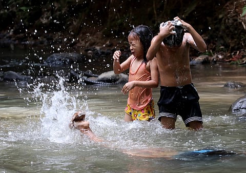 (FILES) Children swimming at the creek in old army road, Barangay Silangan in San Mateo Rizal on 4 July 2023.