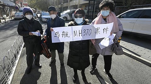 Outside the court, many relatives were on the verge of tears as they recounted stories of their loved ones, some holding pieces of paper saying "restart the search" and "open, fair, impartial". (Pedro PARDO / AFP)