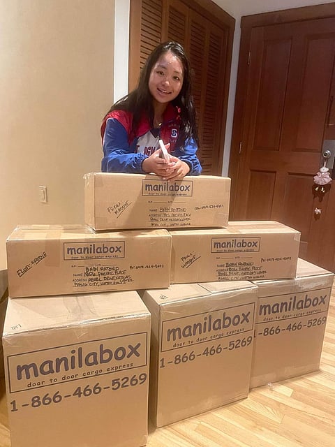 Madie and the boxes of books intended for the children of Tarlac.