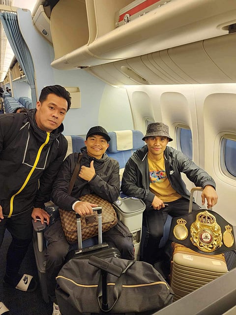 PHOTOGRAPH COURTESY OF SanMan Boxing
Marlon Tapales and his team strike a pose at the Tom Bradley Terminal in Los Angeles as they prepare to head to the Philippines.