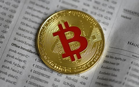 FILE PHOTO: The photo shows a physical imitation of a Bitcoin in Dortmund, western Germany. (Photo by INA FASSBENDER / AFP)