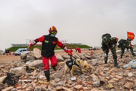 FILE PHOTO: This photo taken on 11 May 2022 shows rescue workers taking part in an earthquake rescue training drill in Zhangye in China's northwestern Gansu province. (Photo by AFP)