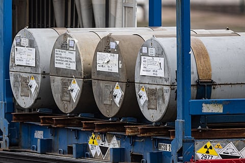 This photograph taken on March 20, 2023, shows cylinders of uranium from the Russian cargo ship the Baltiyskiy 202, unloaded at the port of Dunkirk, northern France. Photo by Sameer Al-DOUMY / AFP
