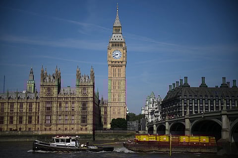 A tow boat goes past Palace of Westminster, home to the Houses of Parliament, and the Elizabeth Tower, commonly known by the name of the bell "Big Ben", in London on 15 June 2023. (Photo by Daniel LEAL / AFP)