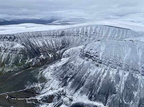 An aerial view captured from a helicopter shows the ice cap, snow and rivers on top of mountains in the Arctic Norwegian Svalbard Archipelago, northern Norway, on September 13, 2023. Photo by Viken KANTARCI / AFP